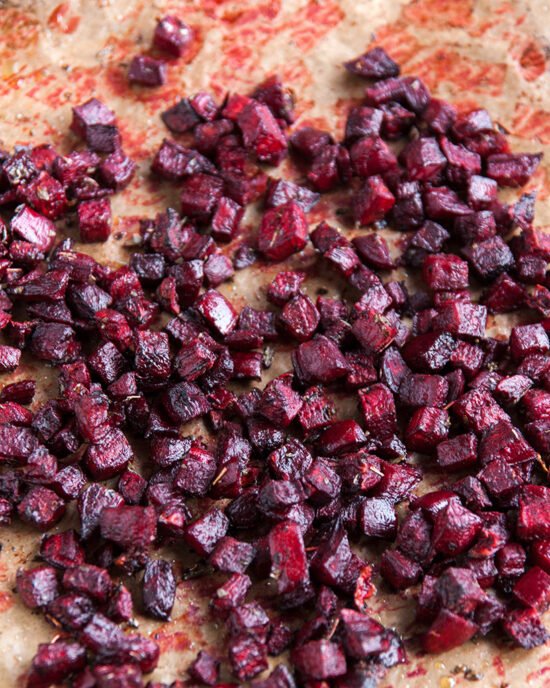 Pečena cikla narezana na kockice raširena po plehu.